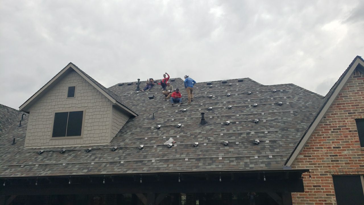 Heckadon roofing crew installing shingles on a residential roof
