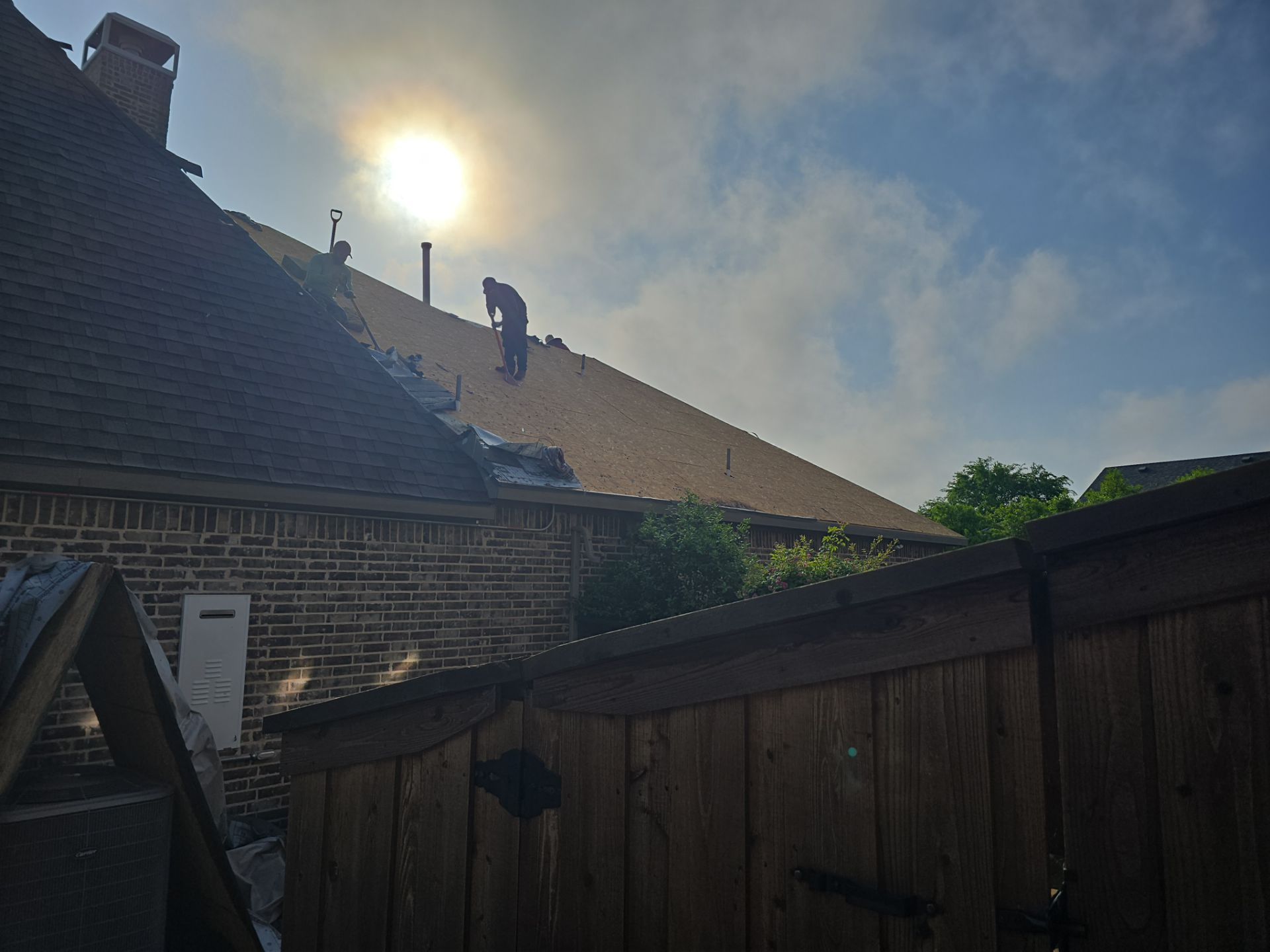 Crew performing residential roofing work